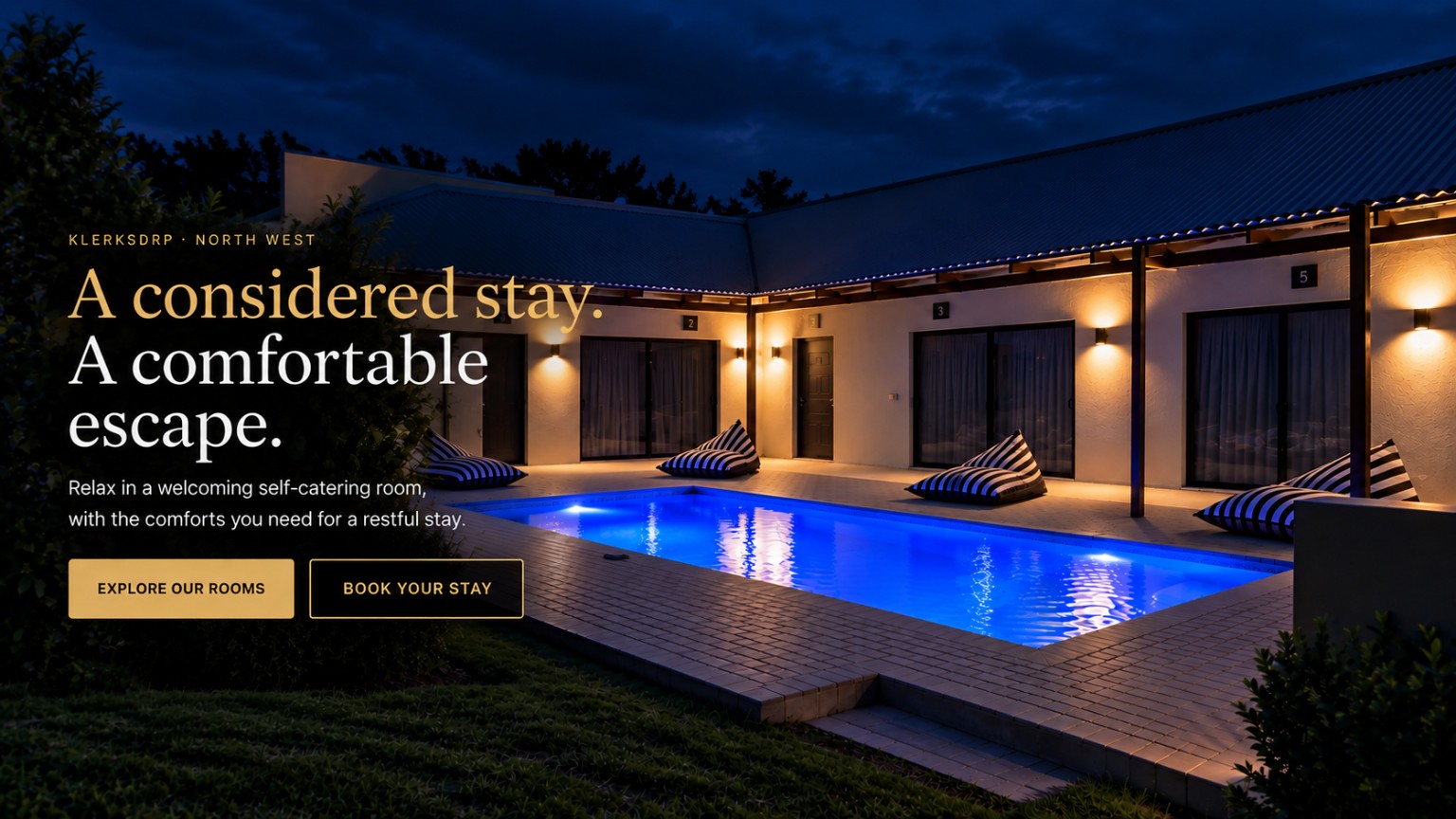 Vlakvark Guesthouse exterior at night with illuminated pool